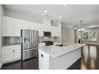 Bright kitchen features a large island with granite countertops and stainless steel appliances at 1829 Hislop Ln, Atlanta, GA 30345