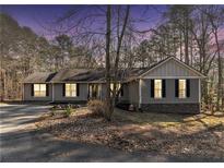 Charming exterior view of a single-Gathering home with gray siding and a well-maintained front yard at 675 Mayes, Powder Springs, GA 30127