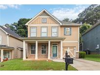 Charming two-story home featuring a welcoming front porch and well-maintained lawn in a residential neighborhood at 1777 Meadow Sw Ln, Atlanta, GA 30315