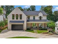 Beautiful brick two-story home with a dark roof, inviting front porch, and well-manicured lawn at 819 Loridans Dr, Atlanta, GA 30342