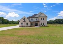 Charming two-story home with brick exterior and well-manicured lawn at 3284 Hall Rd, Dacula, GA 30019