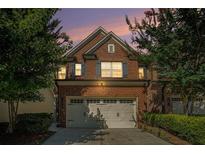 Charming brick home exterior with two-car garage and well-maintained landscaping at 49 Braemore Mill Dr, Lawrenceville, GA 30044