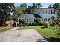 Charming home featuring a well-manicured front yard and a spacious two-car driveway at 6403 Charter Way, Lithonia, GA 30058