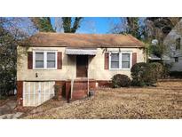 Charming one-story home with siding and a covered front entry, showcasing its classic curb appeal at 1235 Westboro Sw Dr, Atlanta, GA 30310