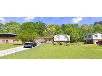 Charming single-Gathering home featuring a spacious front yard and mature trees in a serene neighborhood at 4218 Carlos Ct, Powder Springs, GA 30127