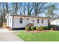 Charming single-story home with a landscaped front yard, complemented by a quaint entrance and fresh exterior at 1084 Fairburn Nw Rd, Atlanta, GA 30331