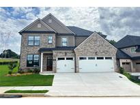 Beautiful two-story home with a two-car garage, brick accents, and a well-manicured lawn at 4190 Hosch Reserve Dr, Buford, GA 30519