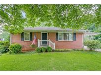 Charming single story brick home with lush green lawn and manicured landscaping at 2194 Freydale Se Rd, Marietta, GA 30067