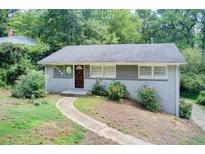 Charming single story home with brick exterior and landscaped front yard nestled among mature trees at 1834 Buckeye Sw St, Atlanta, GA 30310