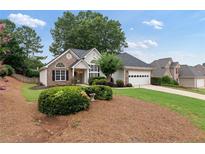Charming single-Gathering home featuring a brick and siding exterior, well-manicured lawn, and two-car garage in a desirable neighborhood at 3549 Daventry Nw Ln, Kennesaw, GA 30144