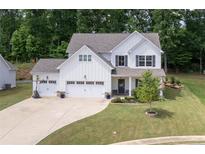Charming two-story home with a well-manicured lawn, three-car garage, and a classic American aesthetic at 197 Stafford Ln, Villa Rica, GA 30180