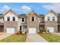 Charming townhomes feature brick and siding exteriors, attached garages, and manicured lawns at 361 Navigator Ln, Mcdonough, GA 30253