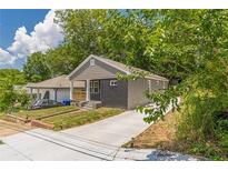 Charming home featuring a brick facade, freshly painted with a new front porch and updated landscaping at 299 Fletcher Sw St, Atlanta, GA 30315