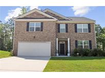 Charming two-story brick home featuring a two-car garage, dark shutters, and a well-manicured lawn at 450 Noblewood Dr, Mcdonough, GA 30252