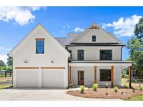 Charming two-story home featuring a symmetrical facade, two-car garage, and inviting front porch at 5125 Hyde Trl, Cumming, GA 30040