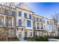 Charming brick townhomes with inviting balconies and classic architectural details, all set against a clear blue sky at 280 Briscoe Way # 38, Alpharetta, GA 30009