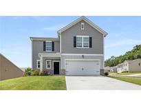 Charming two-story home features gray siding, black shutters, and a well-maintained front yard at 198 Colbury St, Villa Rica, GA 30180