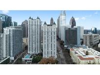 An exterior view of a residential high-rise with a visible pool and city skyline at 199 14Th Ne St # 3003, Atlanta, GA 30309