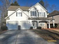 Charming two-story home features a two-car garage and a well-maintained front yard at 3324 Whitmore Ct, Acworth, GA 30101