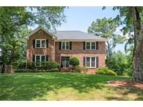 Charming two-story brick home with well-manicured lawn and mature trees in a desirable neighborhood at 2251 Rushmore Dr, Marietta, GA 30062