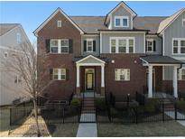 Charming townhome with brick and gray siding, black shutters, and a gated front yard at 2736 Bell Se Dr, Smyrna, GA 30080
