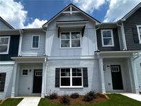 New two-story townhome with white brick, dark shutters, and craftsman-style details at 1909 Victoria Way # 116, Conyers, GA 30013