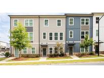 Modern townhome features colorful siding, manicured landscaping, and inviting entrances at 1190 Buice Lake Pkwy, Acworth, GA 30102
