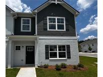 Charming two-story home with a brick facade, complemented by a well-maintained lawn and appealing architectural details at 1911 Victoria Way # 117, Conyers, GA 30013