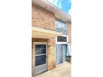 Brick condo exterior featuring sliding glass doors and a security camera for added peace of mind at 4701 Flat Shoals Rd # 25F, Union City, GA 30291