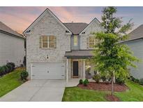 Charming two-story home with a white brick facade, attached garage, and a well-maintained landscaped yard at 1250 Grove Pkwy, Jonesboro, GA 30236