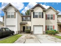 Charming townhome features varied shutters, attached garages, and inviting curb appeal at 1540 Rogers Preserve Rd, Lithonia, GA 30058