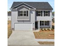 Charming two-story home featuring a two-car garage and classic architectural details at 8587 Secretariat Dr, Lithonia, GA 30058