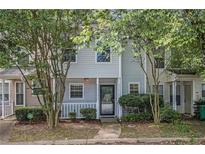 Charming townhome with a welcoming front porch and well-maintained landscaping at 2376 Wellington Cir, Lithonia, GA 30058
