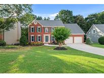 Charming brick home with manicured lawn, two-car garage and beautiful curb appeal at 179 Hunters Crk, Dallas, GA 30157