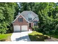 Charming brick two-story home with a two-car garage and lush landscaping at 1614 Summersweet Ln, Dacula, GA 30019