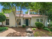 Charming home featuring a well-manicured yard, lush trees, and a welcoming exterior at 837 Serramonte Dr, Marietta, GA 30068