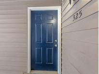 Dark blue six-panel front door with the unit number on the right, providing secure entry at 325 Quail Run, Roswell, GA 30076