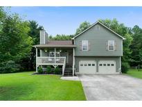 Charming two-story home with a welcoming front porch and a well-manicured lawn at 427 Pleasant Way, Temple, GA 30179