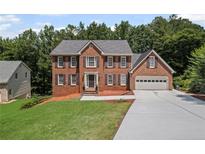 Charming two-story brick home with a well-manicured lawn and a spacious driveway at 1079 Angel Ln, Powder Springs, GA 30127