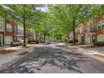 Charming street view showcasing townhomes and tree-lined street in a well-kept neighborhood at 2160 Dillard Xing, Tucker, GA 30084