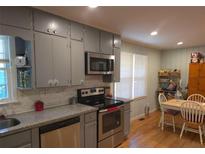 Eat-in kitchen featuring stainless appliances and gray cabinetry at 439 River Rd, Jonesboro, GA 30236