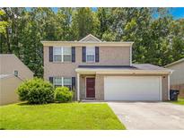 Charming two-story home with brick facade, blue shutters, and well-maintained front lawn at 5622 Laurel Ridge Dr, Atlanta, GA 30344