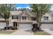 Charming townhome with stone accents, attached garage and well-maintained landscaping at 407 Mountain View Ln, Woodstock, GA 30188