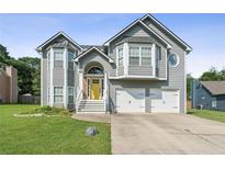 Charming two-story home with a well-manicured lawn, a bright yellow door, and a two-car garage at 30 Freedom Ne Dr, Cartersville, GA 30121