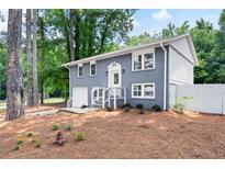 Charming split-level home features a grey brick facade and a well-manicured front yard at 2099 Redbud Sw Ct, Marietta, GA 30008