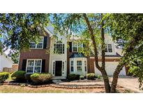 Charming two-story brick and vinyl home with a well-maintained lawn and inviting curb appeal at 2565 Rainmaker Dr, Decatur, GA 30034