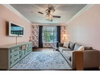 Cozy living room with stylish decor, plush sofa, and a patterned rug at 955 Juniper Ne St # 4127, Atlanta, GA 30309