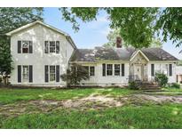 Charming two-story home featuring a stone facade and neutral exterior with a partially wooded front yard at 10 Shadburn Ferry Rd, Buford, GA 30518