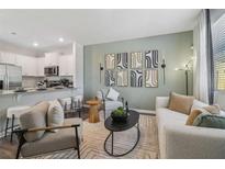 Cozy living room featuring modern furnishings and an open layout to the kitchen at 1398 Sweetshrub Pl # 32, Atlanta, GA 30318