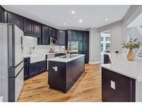 This kitchen features custom navy cabinets, stainless steel appliances, an island, and white countertops at 3860 Overlake Dr, Cumming, GA 30041
